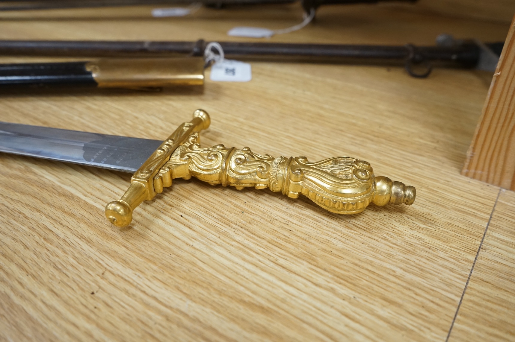 A Scottish sidearm for the King’s Own Bodyguard for Scotland, straight blade by J. Stewart and Son, etched and polished regulation blade, ormolu hilt, in its leather scabbard with ormolu mounts (gilding worn to mounts)